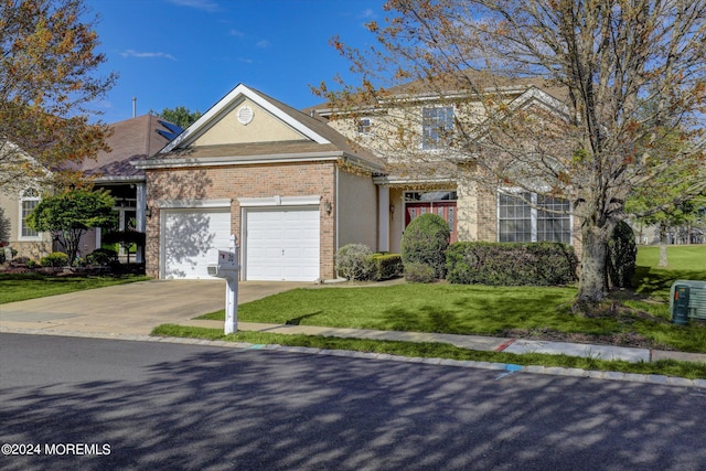 view of front of property featuring a garage and a front yard