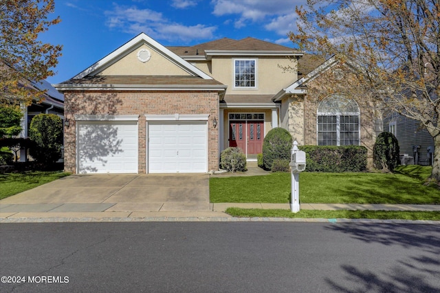 view of property with a front yard and a garage