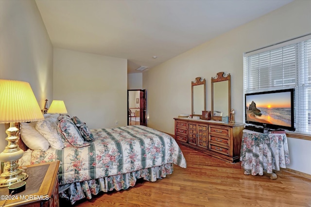 bedroom with hardwood / wood-style floors