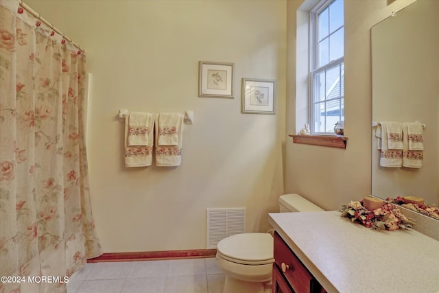 bathroom with toilet, tile flooring, and vanity