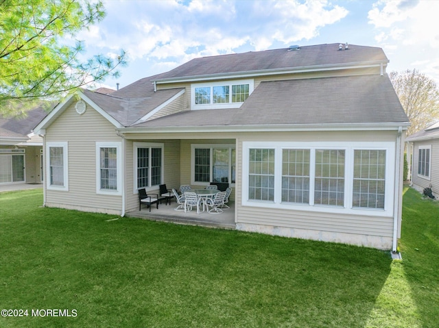 back of property featuring a lawn and a patio area