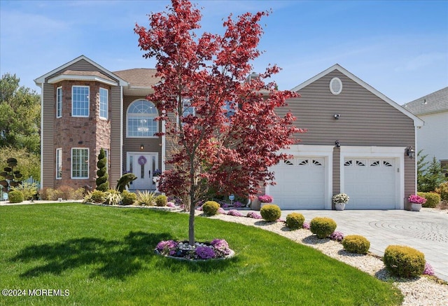 view of front property with a garage and a front lawn