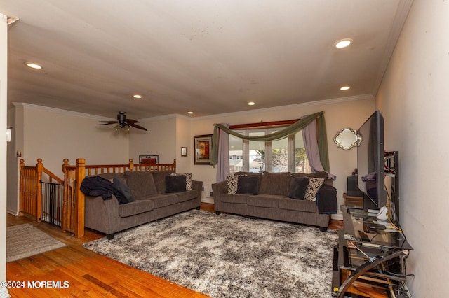 living room featuring hardwood / wood-style flooring, ceiling fan, and ornamental molding