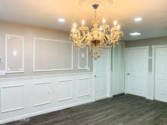 interior space with a chandelier and dark hardwood / wood-style floors