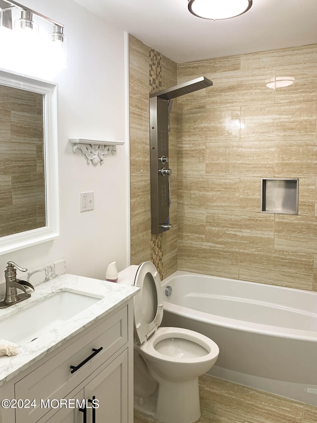 full bathroom featuring vanity, toilet, and tiled shower / bath