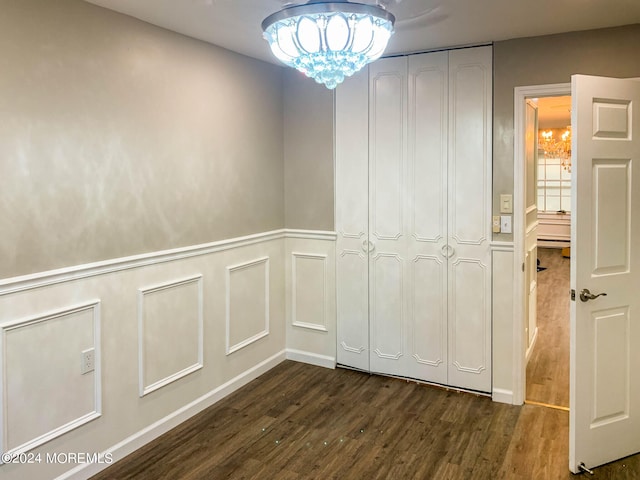 hallway with dark hardwood / wood-style floors, an inviting chandelier, and baseboard heating