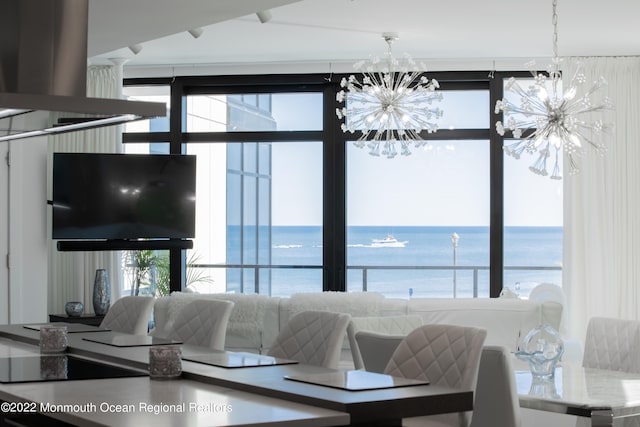 living room featuring a water view and a chandelier