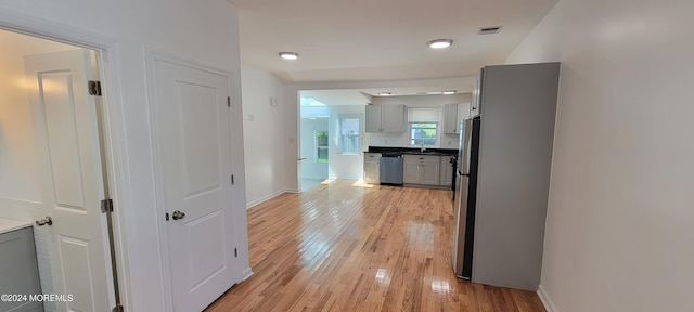 corridor with light hardwood / wood-style floors