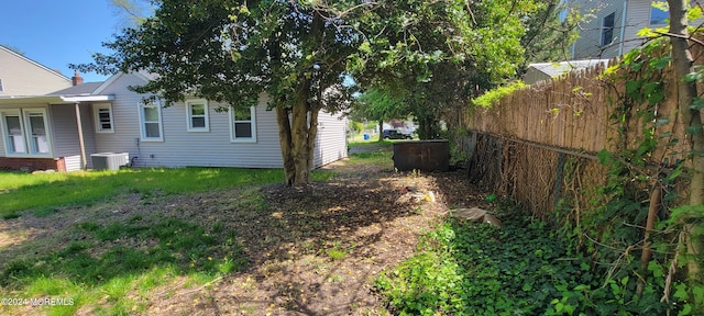 view of yard with central air condition unit