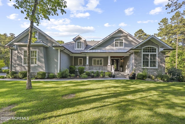 craftsman-style home featuring a porch and a front yard