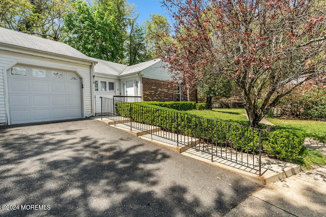 view of front of property with aphalt driveway, brick siding, and a garage