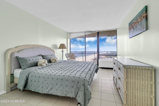 bedroom featuring access to outside and light tile patterned flooring