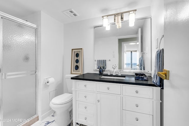 bathroom with an enclosed shower, vanity, and toilet