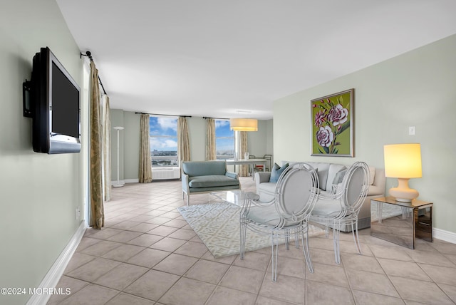 living room featuring light tile patterned flooring and a barn door