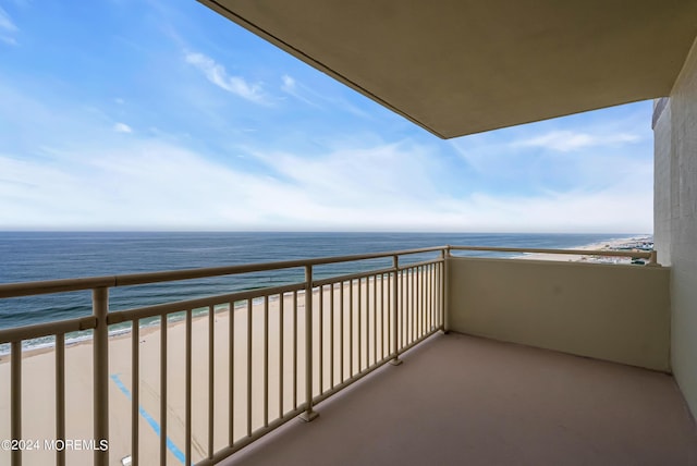 balcony featuring a water view and a view of the beach