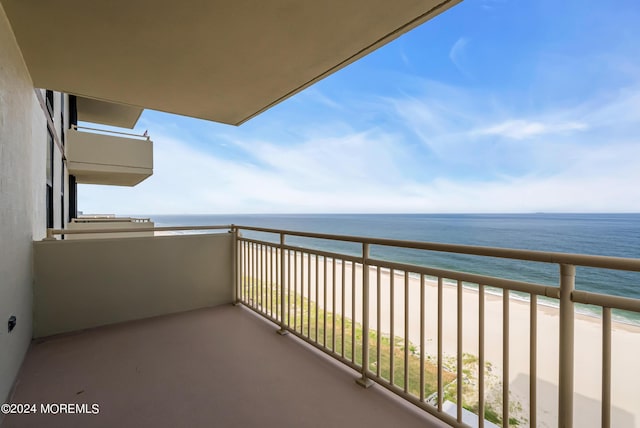 balcony with a beach view and a water view