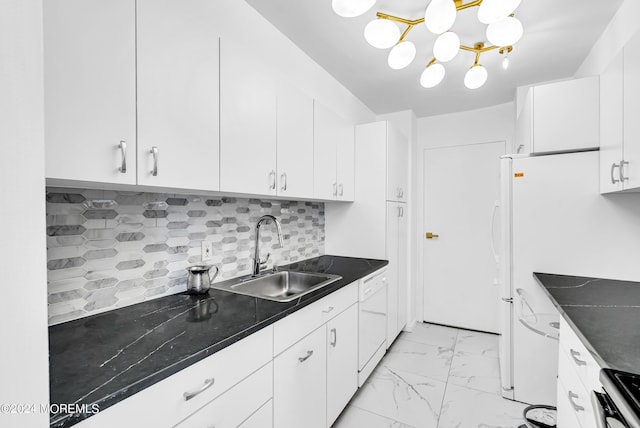 kitchen featuring sink, backsplash, white cabinets, and white appliances