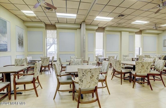 dining room with a drop ceiling and ceiling fan