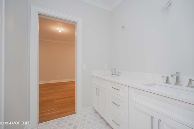 bathroom with ornamental molding, vanity, and wood-type flooring