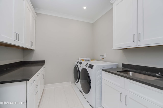 laundry area featuring independent washer and dryer, ornamental molding, cabinets, and sink