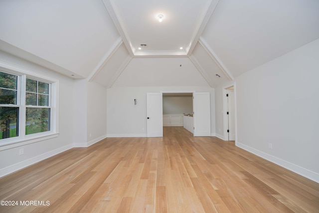 additional living space with vaulted ceiling with beams and light hardwood / wood-style floors