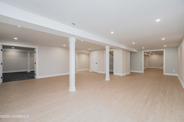 basement with light hardwood / wood-style flooring