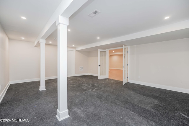 basement featuring dark colored carpet