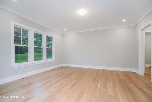 unfurnished room with light hardwood / wood-style flooring and crown molding