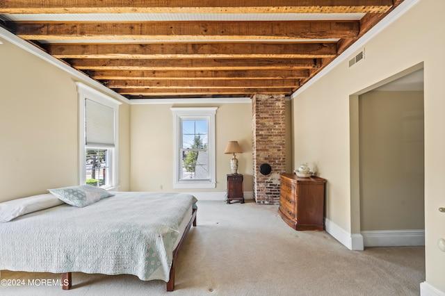 bedroom featuring brick wall, carpet flooring, beam ceiling, and crown molding