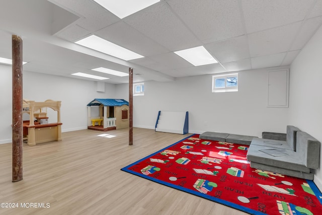 game room with wood-type flooring and a paneled ceiling