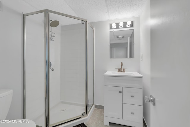 bathroom featuring tile patterned flooring, vanity, toilet, and a shower with shower door