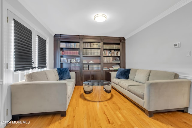 living room featuring hardwood / wood-style flooring and ornamental molding