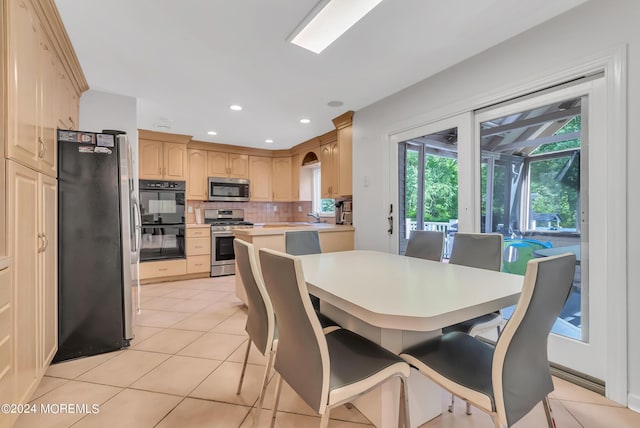 dining area with light tile patterned floors and sink