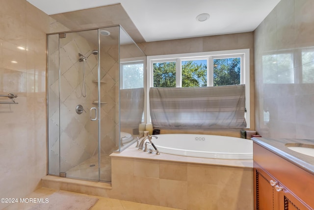 bathroom featuring tile patterned floors, vanity, and shower with separate bathtub