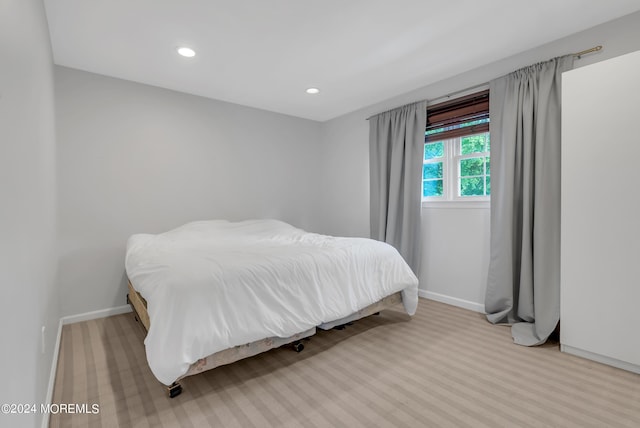 bedroom featuring light colored carpet