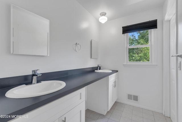 bathroom featuring tile patterned flooring and vanity