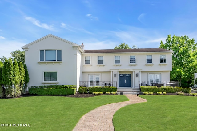 view of front of home featuring french doors and a front lawn