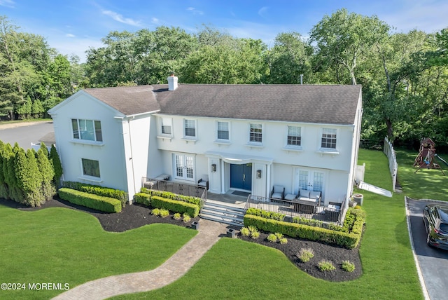 view of front of house featuring outdoor lounge area, french doors, and a front lawn