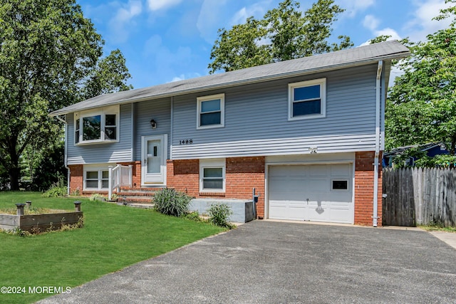 bi-level home with a front yard and a garage