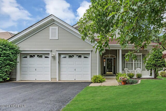 view of front of house with a garage and a front yard