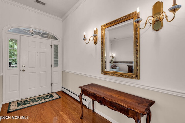 entrance foyer with crown molding, baseboard heating, and hardwood / wood-style flooring