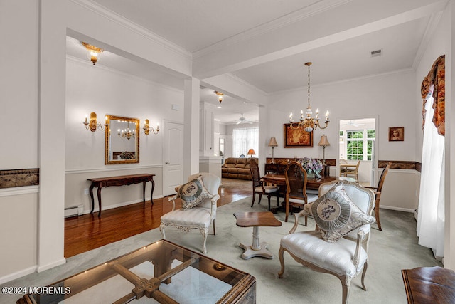 living room featuring light hardwood / wood-style flooring, crown molding, baseboard heating, and a notable chandelier