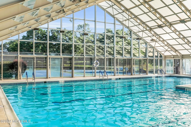 view of swimming pool with glass enclosure