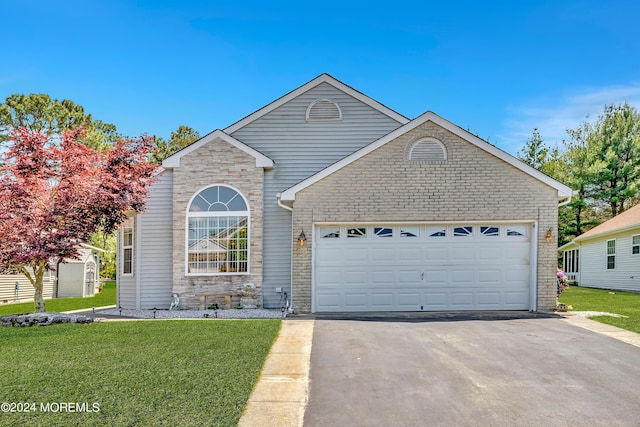 64 Canterbury Ln, Toms River, NJ 08757 - traditional-style house with stone siding, an attached garage, a front yard, and aphalt driveway