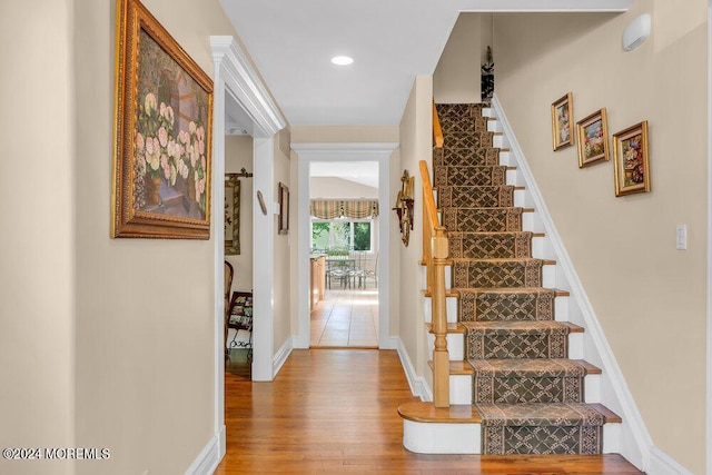 stairway with hardwood / wood-style floors