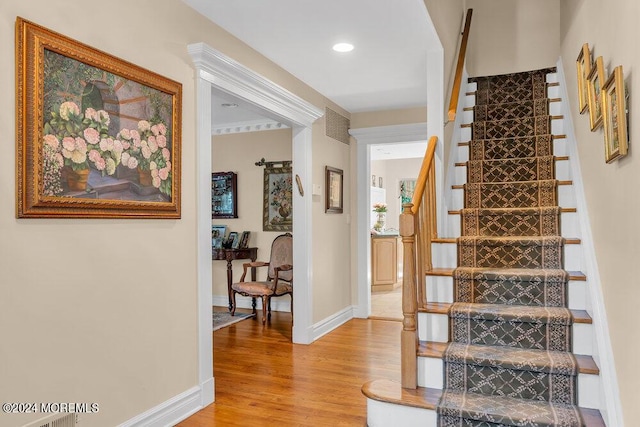 stairs with hardwood / wood-style flooring