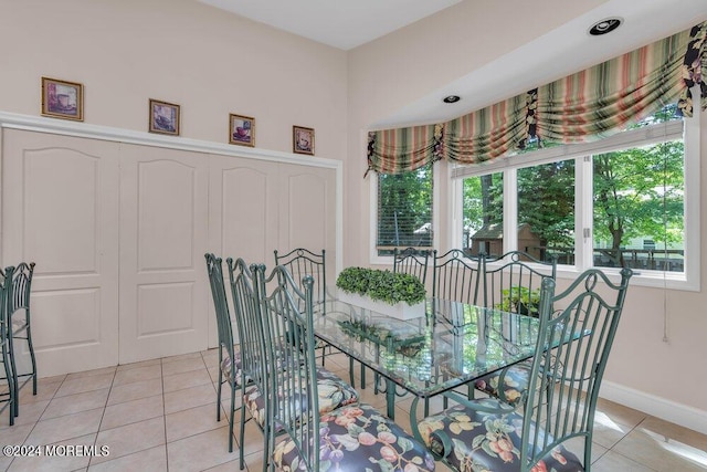 tiled dining space featuring plenty of natural light