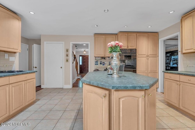 kitchen featuring tasteful backsplash, light brown cabinets, and a kitchen island