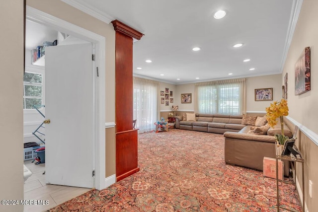 tiled living room with plenty of natural light and crown molding