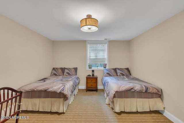 bedroom featuring light carpet